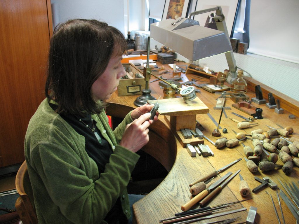 Julia at the gravure's bench filing, Imprimerie Nationale, Orly near Paris.