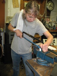 Julia cutting a length of Steel for a new punch